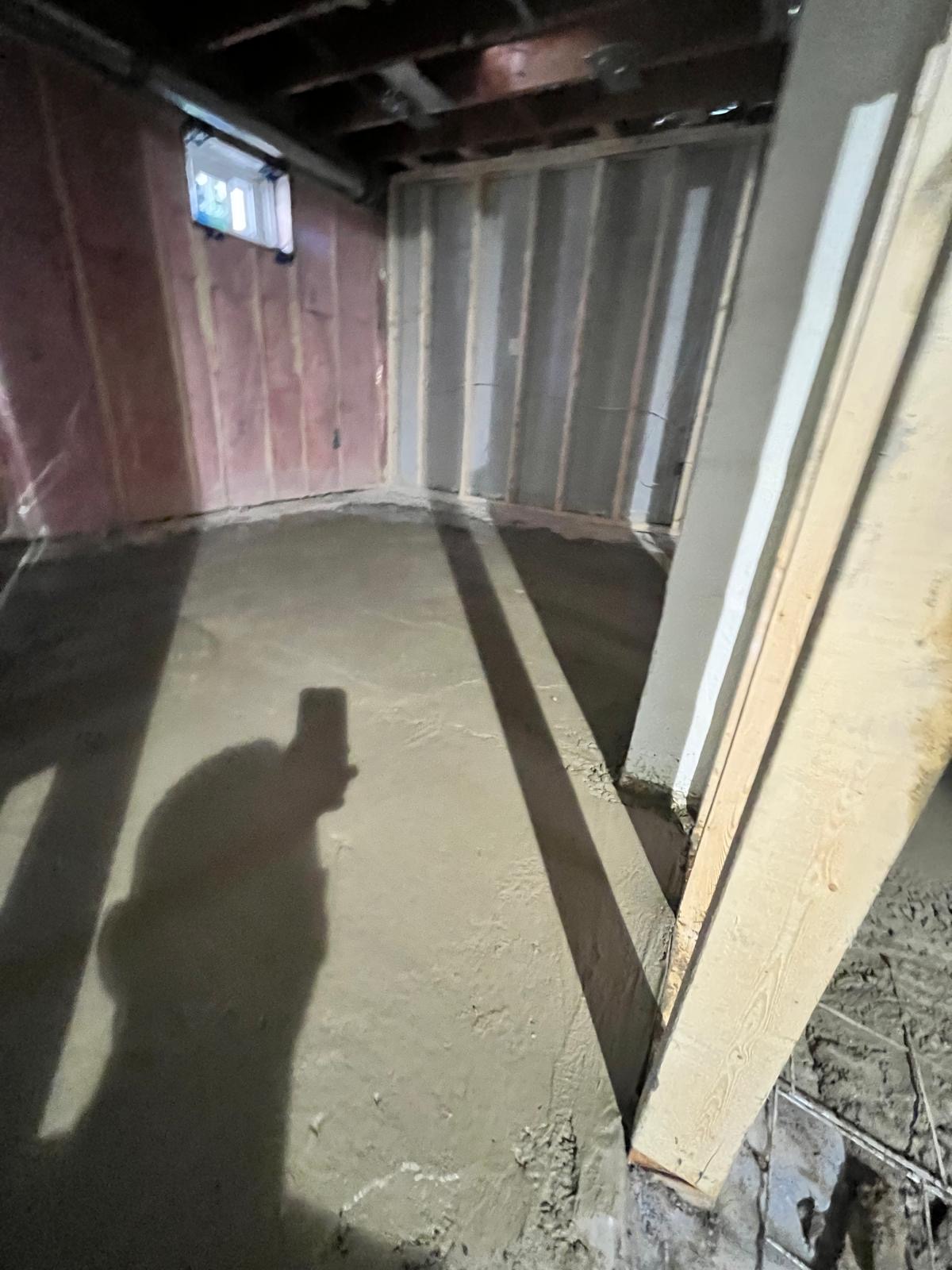 Self-levelling cement freshly poured across a framed basement floor by H&H Flooring in Toronto